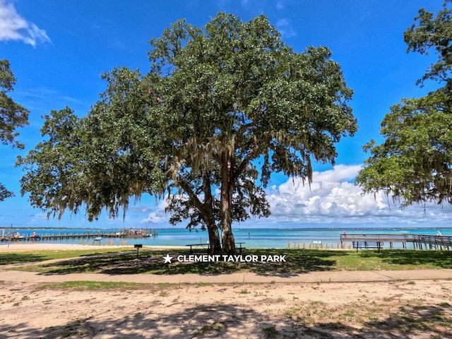 surrounding community featuring a water view and a view of the beach