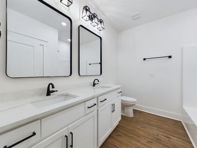 325 Shoal River Dr, Crestview, FL 32539 - bathroom with toilet, vanity, and wood-type flooring