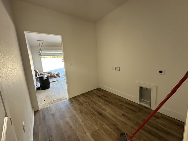 laundry area featuring dark wood-style floors, visible vents, laundry area, electric dryer hookup, and a garage