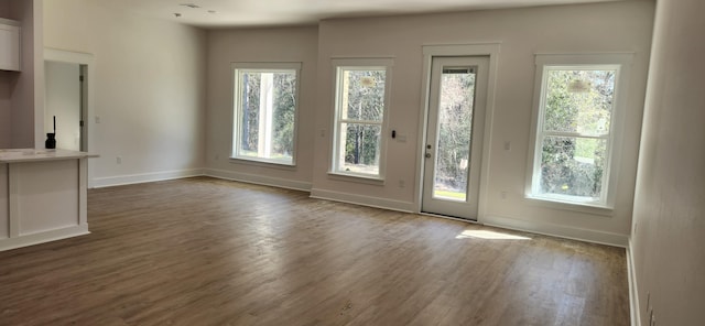 interior space with dark wood finished floors and baseboards