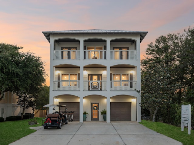 24 High Tide Way, Inlet Beach, FL 32461 - coastal home with a balcony, a garage, driveway, and stucco siding