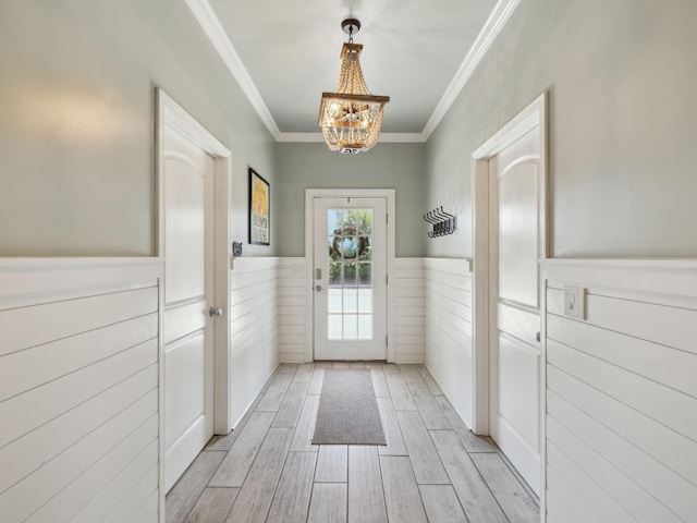 24 High Tide Way, Inlet Beach, FL 32461 - doorway with wainscoting, a chandelier, crown molding, and light wood-type flooring