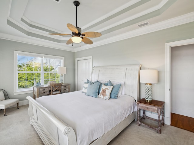 24 High Tide Way, Inlet Beach, FL 32461 - bedroom with a tray ceiling, crown molding, baseboards, and light carpet
