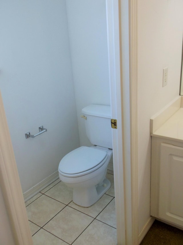 bathroom featuring tile patterned floors, toilet, and vanity