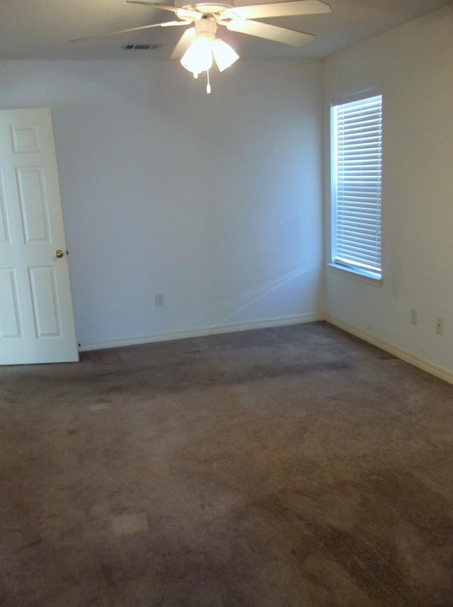 carpeted spare room with ceiling fan