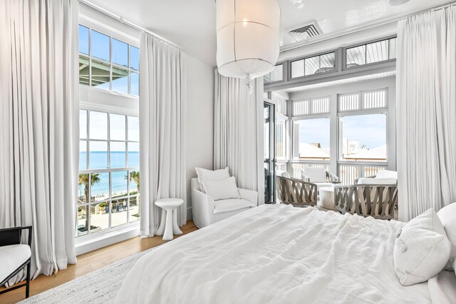 290 Sea Garden St Unit 402, Alys Beach, FL 32461 - bedroom featuring hardwood / wood-style floors and a water view