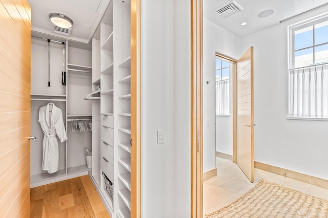 290 Sea Garden St Unit 402, Alys Beach, FL 32461 - walk in closet with light hardwood / wood-style floors