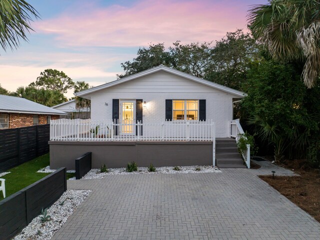 38 Barracuda St, Santa Rosa Beach, FL 32459 - bungalow-style home featuring fence, covered porch, and brick siding
