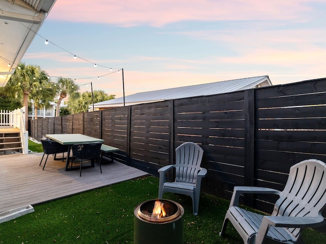 38 Barracuda St, Santa Rosa Beach, FL 32459 - view of yard with outdoor dining area, a wooden deck, an outdoor fire pit, and a fenced backyard