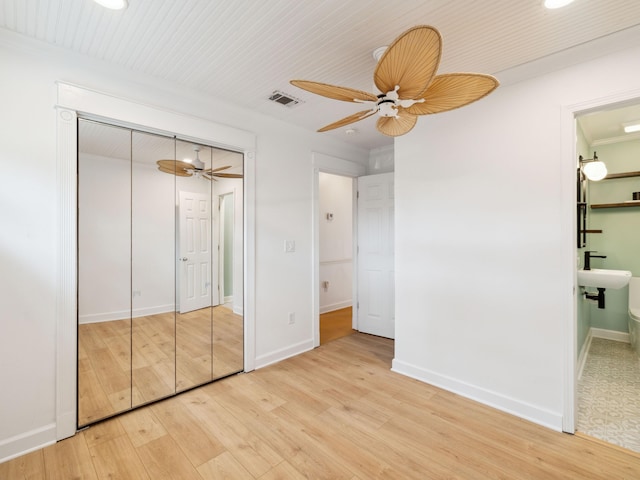 38 Barracuda St, Santa Rosa Beach, FL 32459 - unfurnished bedroom with a ceiling fan, a closet, connected bathroom, light wood-style floors, and visible vents