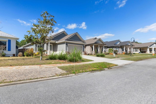 105 Oyster Blvd, Freeport, FL 32439 - view of front of house featuring a garage, a residential view, board and batten siding, and concrete driveway