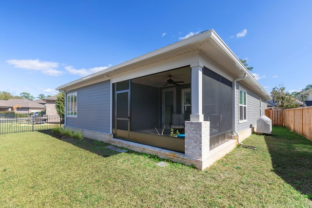 105 Oyster Blvd, Freeport, FL 32439 - view of property exterior with a sunroom, ceiling fan, a lawn, and a fenced backyard