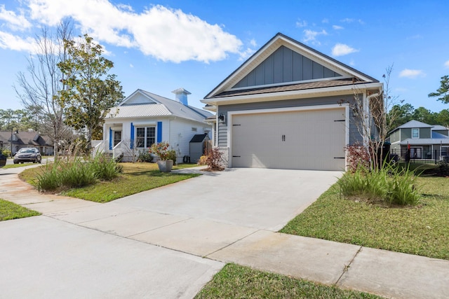 view of front of home with a garage, driveway, a front lawn, and board and batten siding