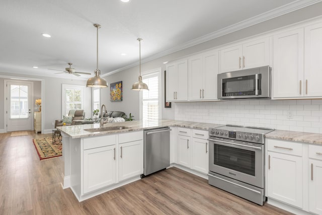 105 Oyster Blvd, Freeport, FL 32439 - kitchen featuring stainless steel appliances, white cabinetry, and a sink