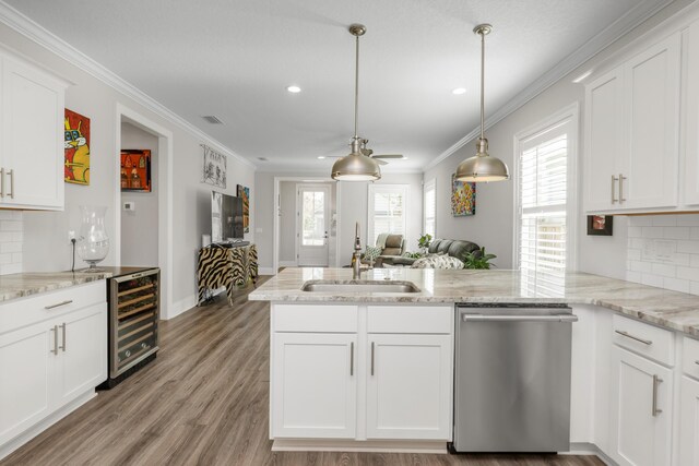 105 Oyster Blvd, Freeport, FL 32439 - kitchen with wine cooler, stainless steel dishwasher, white cabinetry, a sink, and a peninsula