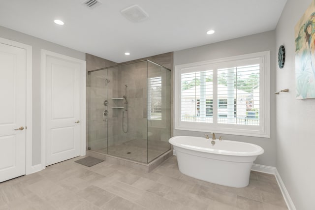105 Oyster Blvd, Freeport, FL 32439 - full bathroom featuring recessed lighting, visible vents, baseboards, a freestanding bath, and a shower stall