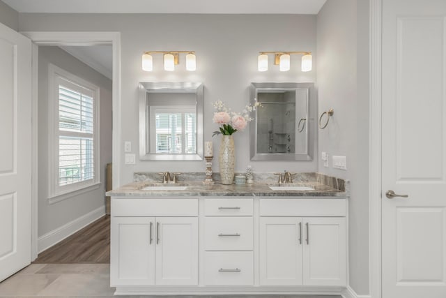 105 Oyster Blvd, Freeport, FL 32439 - bathroom with a shower, a sink, baseboards, and double vanity