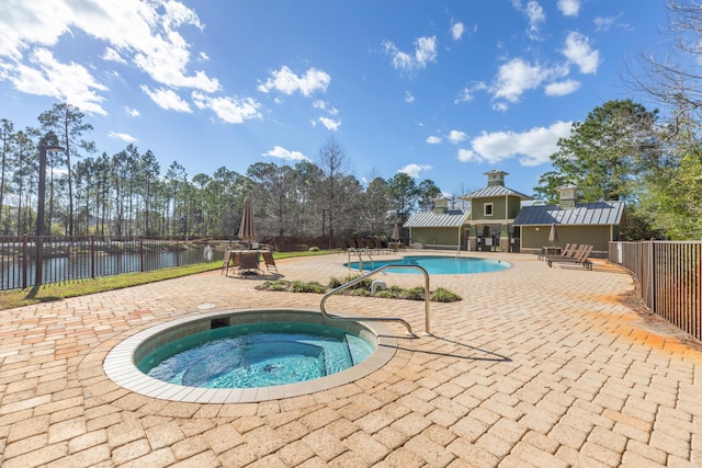 105 Oyster Blvd, Freeport, FL 32439 - view of pool with a fenced in pool, a patio, an in ground hot tub, a water view, and fence