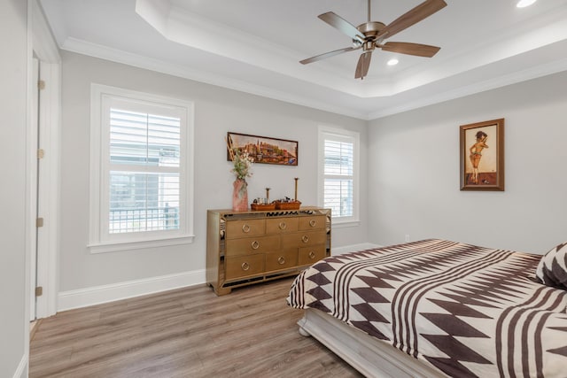 105 Oyster Blvd, Freeport, FL 32439 - bedroom with baseboards, light wood-type flooring, a raised ceiling, and crown molding