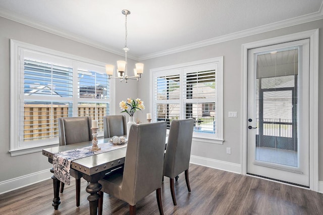 105 Oyster Blvd, Freeport, FL 32439 - dining space featuring dark wood-style floors, crown molding, baseboards, and a notable chandelier