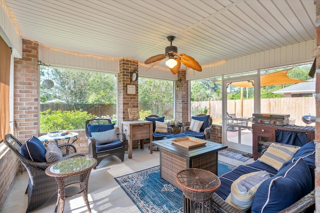 view of patio / terrace featuring ceiling fan and an outdoor living space with a fire pit