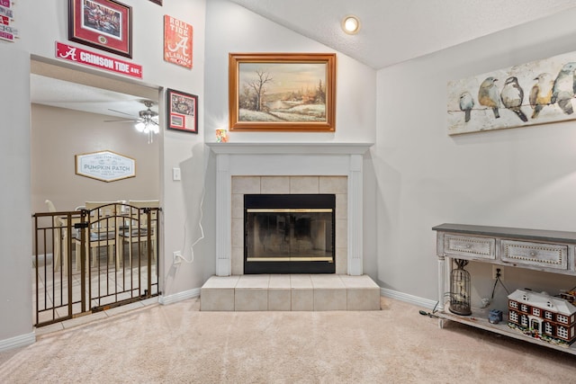 carpeted living room featuring vaulted ceiling, a fireplace, and baseboards