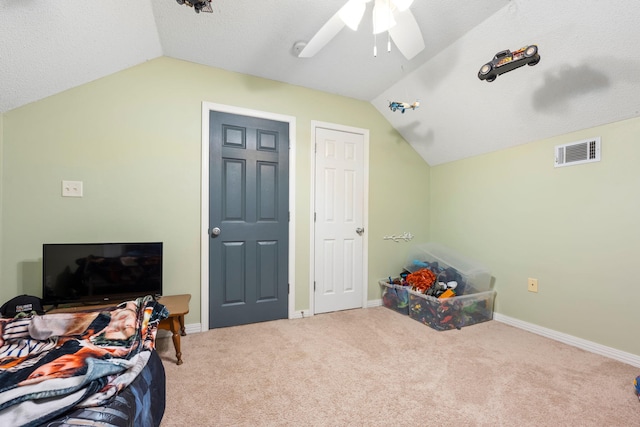 carpeted bedroom with lofted ceiling, baseboards, and visible vents