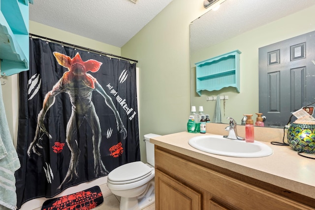 full bathroom featuring tile patterned floors, a textured ceiling, toilet, and vanity