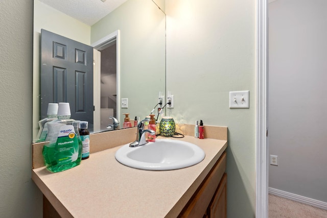 bathroom with vanity and baseboards