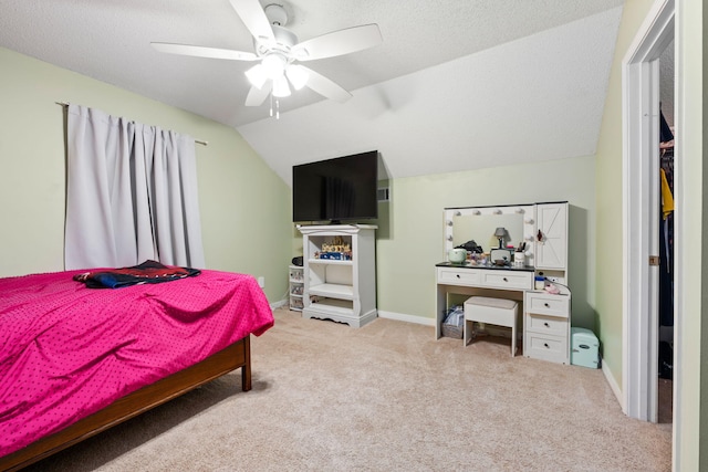 bedroom featuring lofted ceiling, ceiling fan, a textured ceiling, light carpet, and baseboards