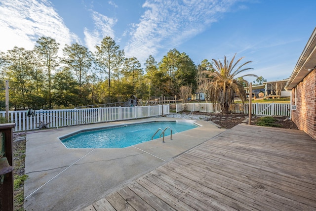 view of pool with a fenced in pool, a fenced backyard, a patio, and a wooden deck