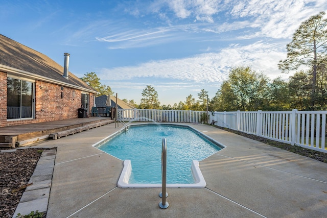 view of pool with a fenced backyard, a fenced in pool, and a wooden deck