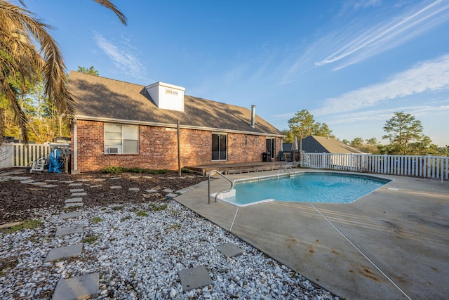 view of pool featuring a patio area, a fenced backyard, cooling unit, and a fenced in pool