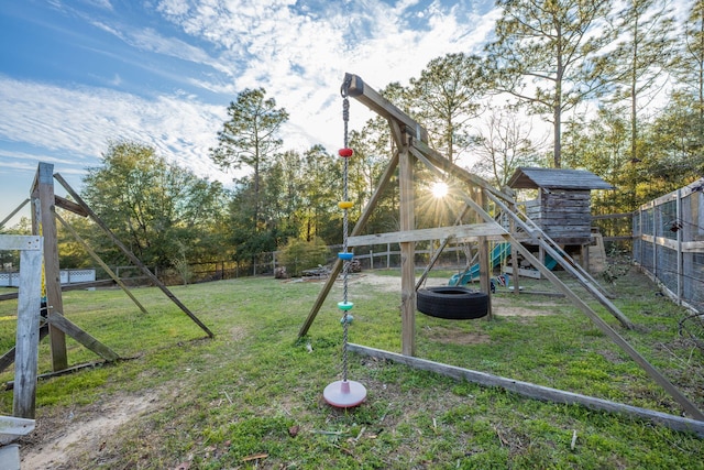 view of playground with a fenced backyard and a lawn