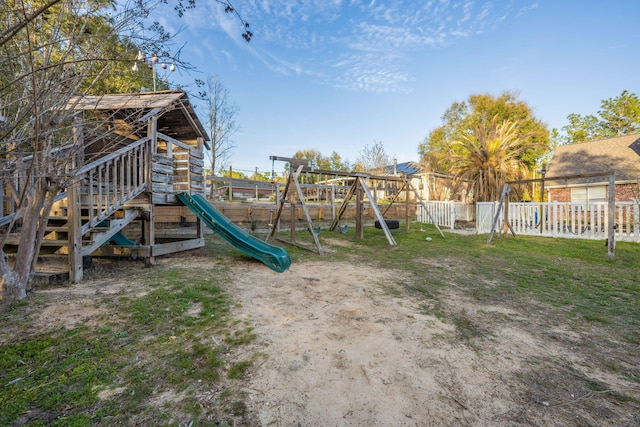 view of playground with a yard and fence