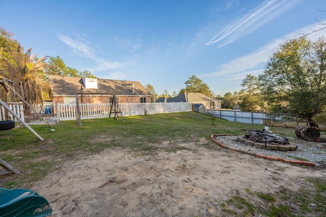 view of yard featuring an outdoor fire pit and fence