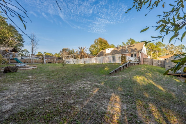 view of yard featuring a fenced backyard and a playground