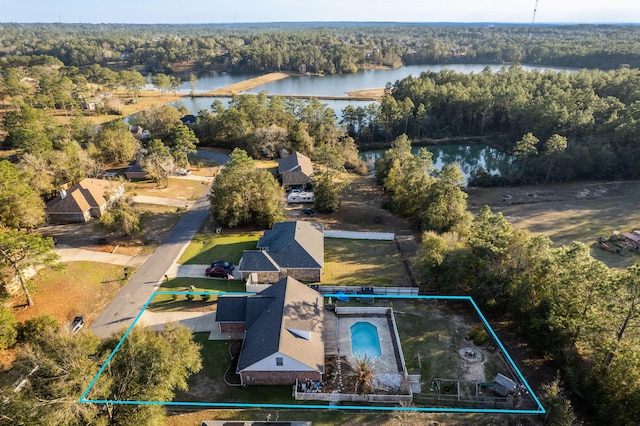 bird's eye view with a water view and a forest view