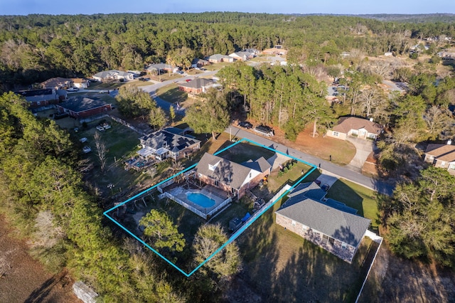 bird's eye view with a residential view and a wooded view