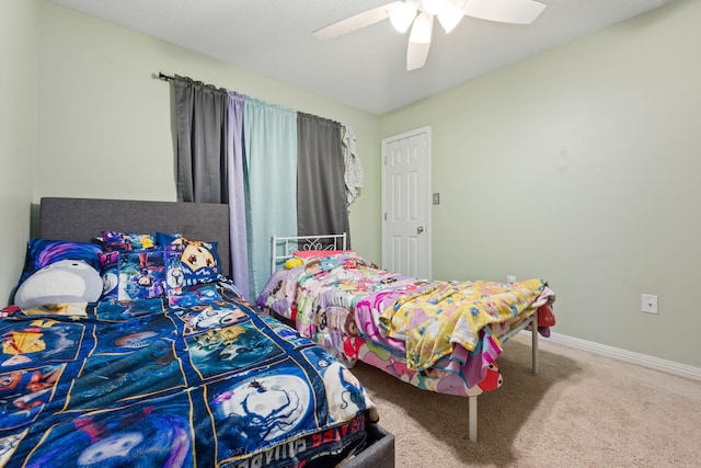 bedroom with carpet floors, ceiling fan, and baseboards