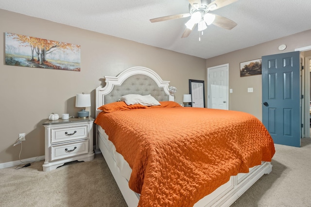 carpeted bedroom with a ceiling fan, a textured ceiling, and baseboards