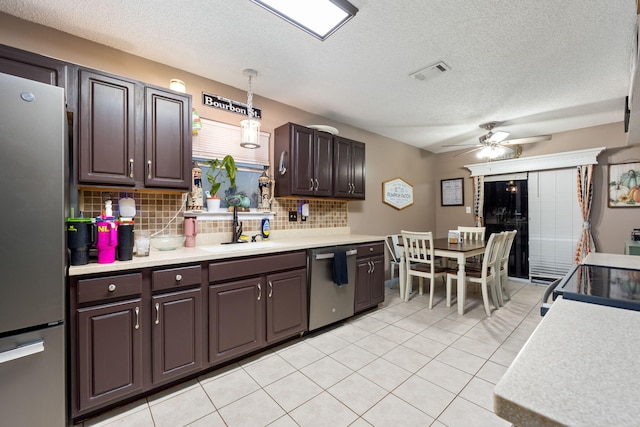 kitchen with stainless steel appliances, visible vents, hanging light fixtures, light countertops, and dark brown cabinets