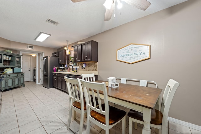 dining room with a ceiling fan, visible vents, and light tile patterned flooring