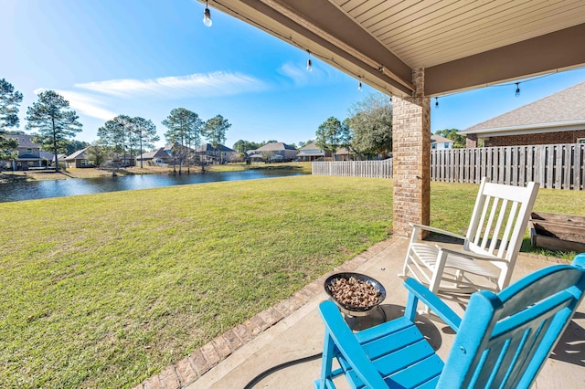 view of yard featuring a water view, a residential view, and fence