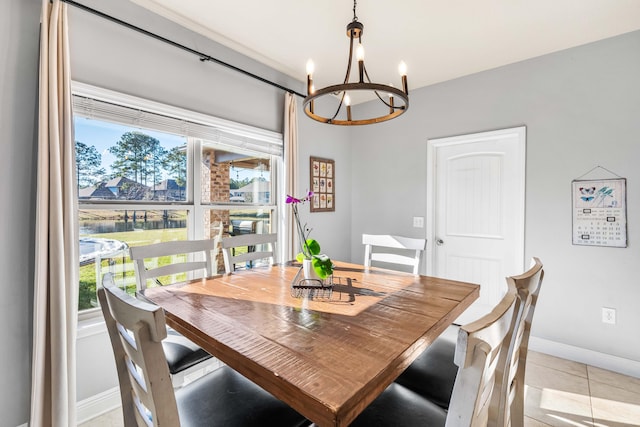 dining space featuring a chandelier, plenty of natural light, baseboards, and light tile patterned floors