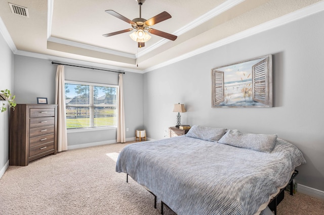 bedroom featuring carpet, visible vents, a tray ceiling, and ornamental molding