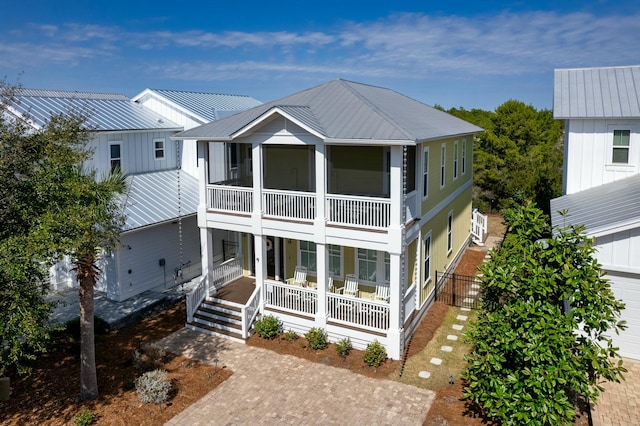 beach home featuring covered porch