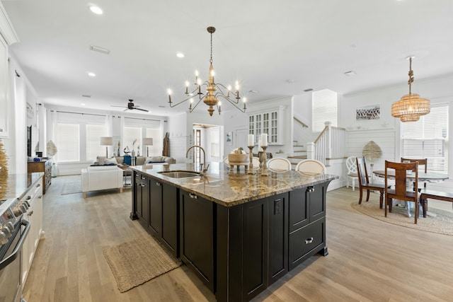 125 Gulfview Cir, Santa Rosa Beach, FL 32459 - kitchen with stainless steel stove, sink, light stone counters, and pendant lighting