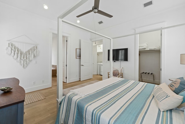 125 Gulfview Cir, Santa Rosa Beach, FL 32459 - bedroom with light wood-type flooring, a closet, washing machine and clothes dryer, and ceiling fan