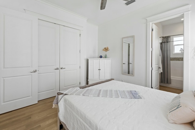 125 Gulfview Cir, Santa Rosa Beach, FL 32459 - bedroom featuring light wood-type flooring, ensuite bath, a closet, ornamental molding, and ceiling fan